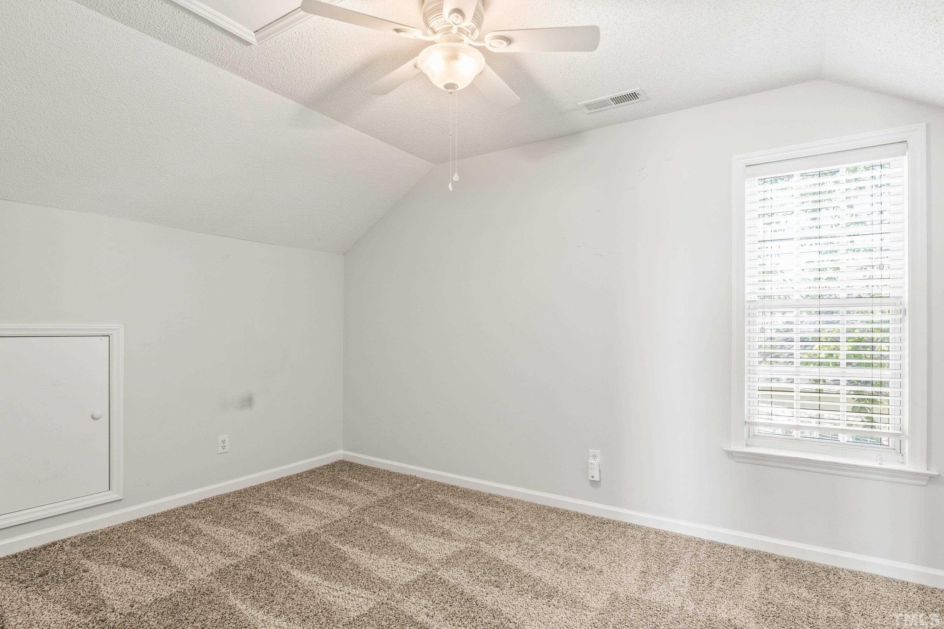 5355 Sahalee Way Raleigh, NC 27604 - Photo 39 of 42 an empty room with a window and a ceiling fan