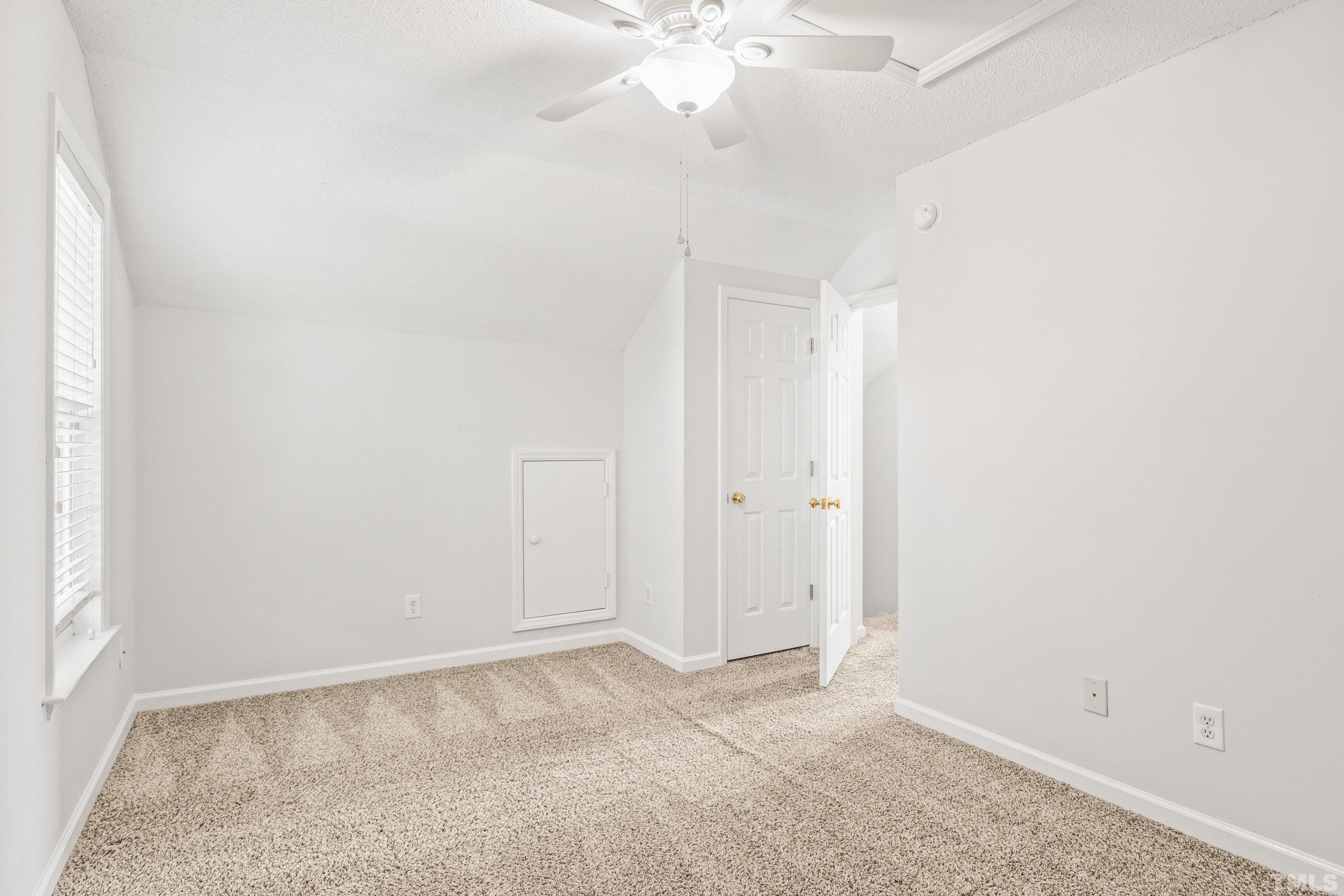 5355 Sahalee Way Raleigh, NC 27604 - Photo 40 of 42 an empty room with a chandelier fan and closet