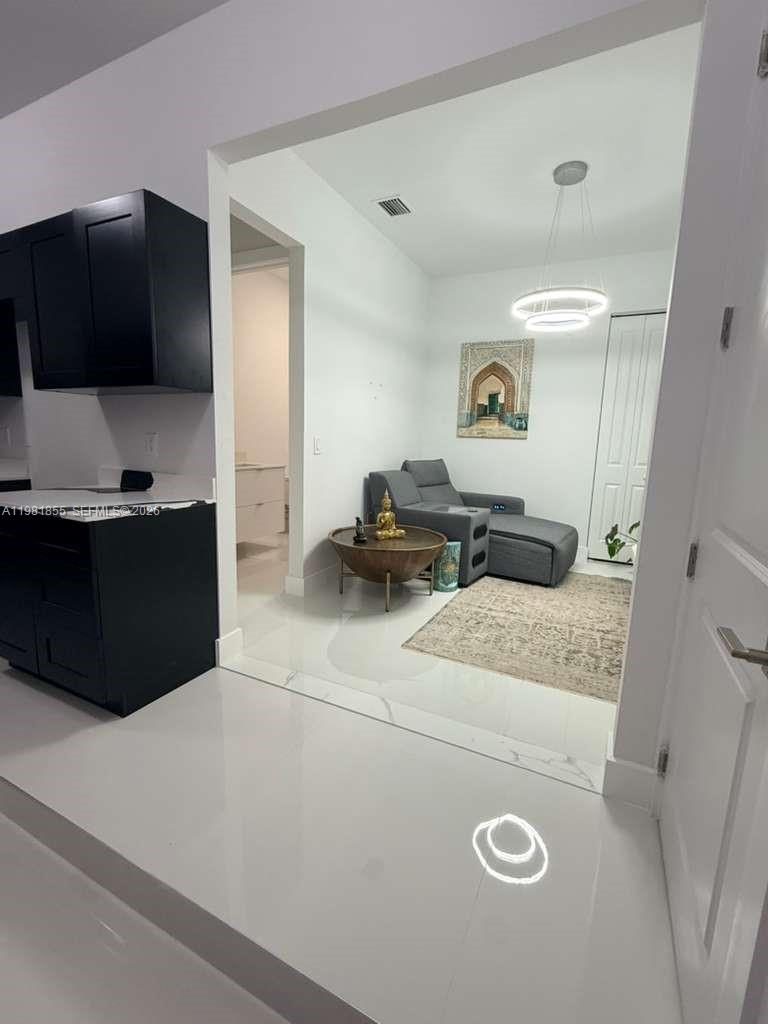 15455 Southwest 232nd Street, Unit A Miami, FL 33170 - Photo 12 of 12 a living room with furniture and a flat screen tv