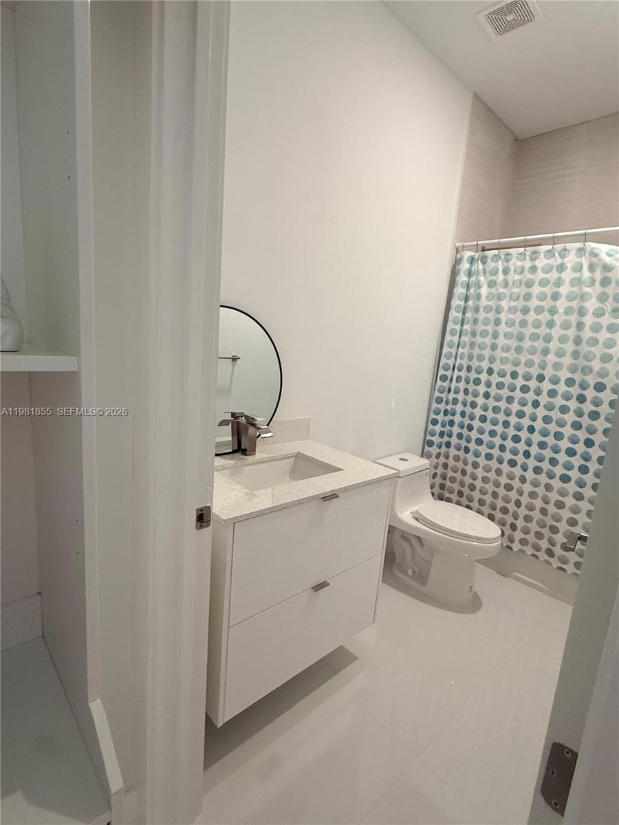 15455 Southwest 232nd Street, Unit A Miami, FL 33170 - Photo 5 of 12 a bathroom with a sink toilet and shower
