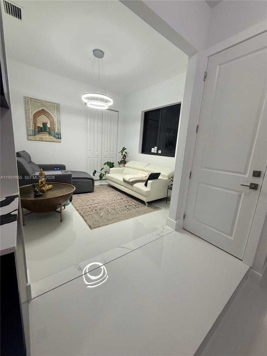 15455 Southwest 232nd Street, Unit A Miami, FL 33170 - Photo 6 of 12 a bedroom with a bed and a flat screen tv