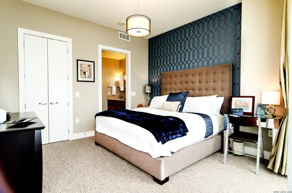 a bedroom with bed and a chandelier