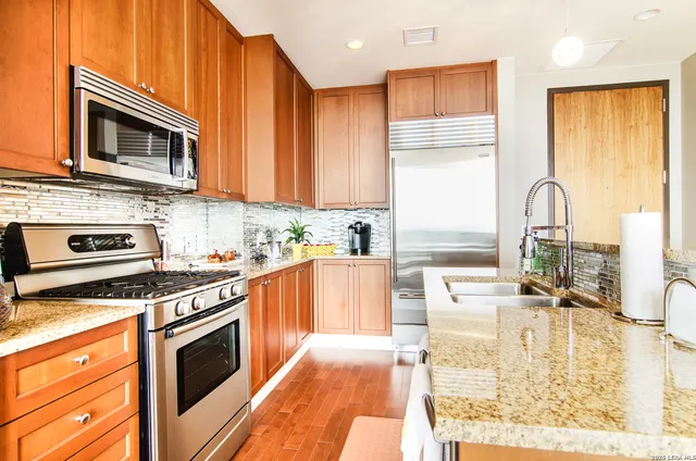 a kitchen with a stove a sink and a microwave