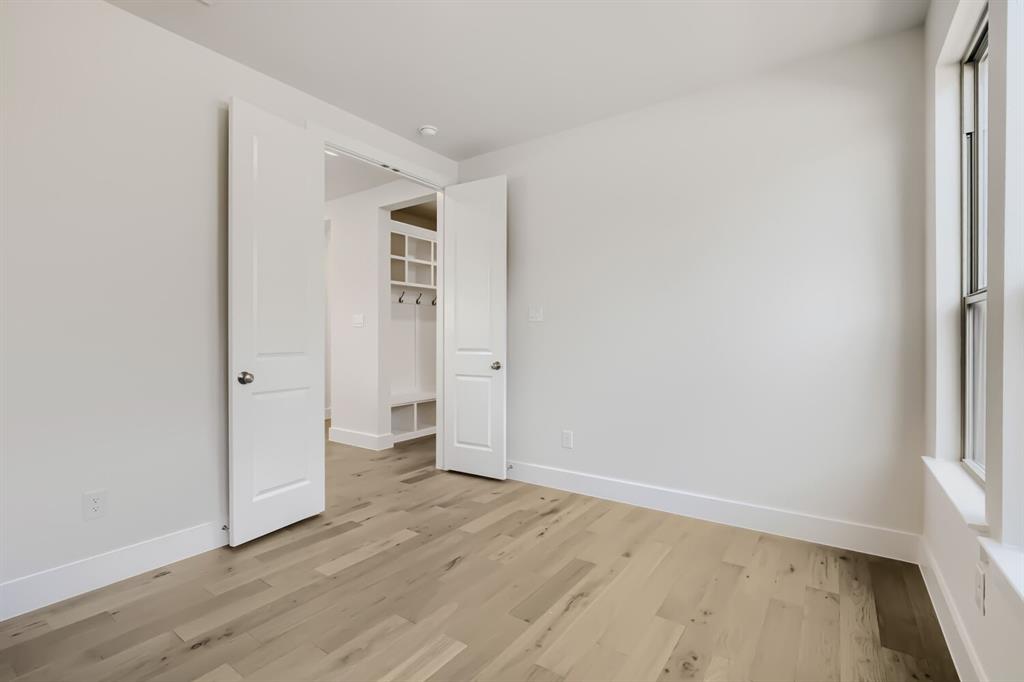 828 Stone Grv Road Lavon, TX 75166 - Photo 13 of 27 Bright room featuring wood-finish flooring, white walls, and a window with white trim