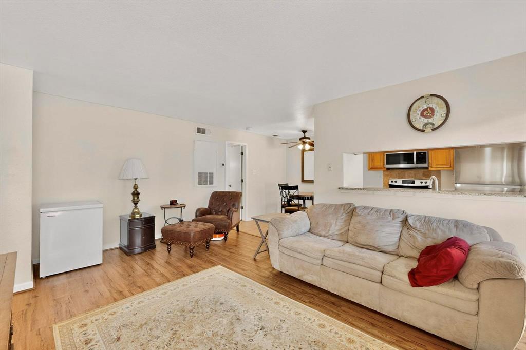 5981 Arapaho Road, Unit 901 Dallas, TX 75248 - Photo 17 of 38 a living room with furniture and wooden floor