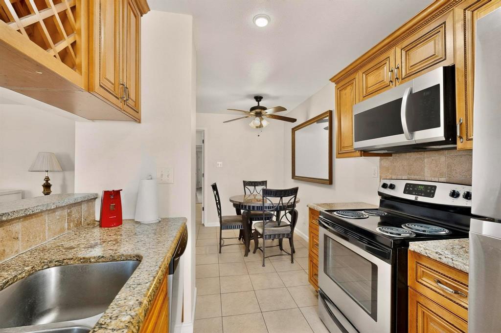 5981 Arapaho Road, Unit 901 Dallas, TX 75248 - Photo 23 of 38 a kitchen with a stove and a sink