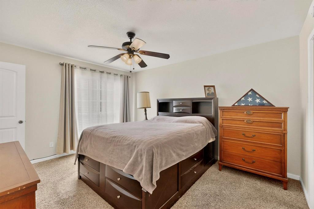 5981 Arapaho Road, Unit 901 Dallas, TX 75248 - Photo 30 of 38 a bedroom with a bed and a chandelier