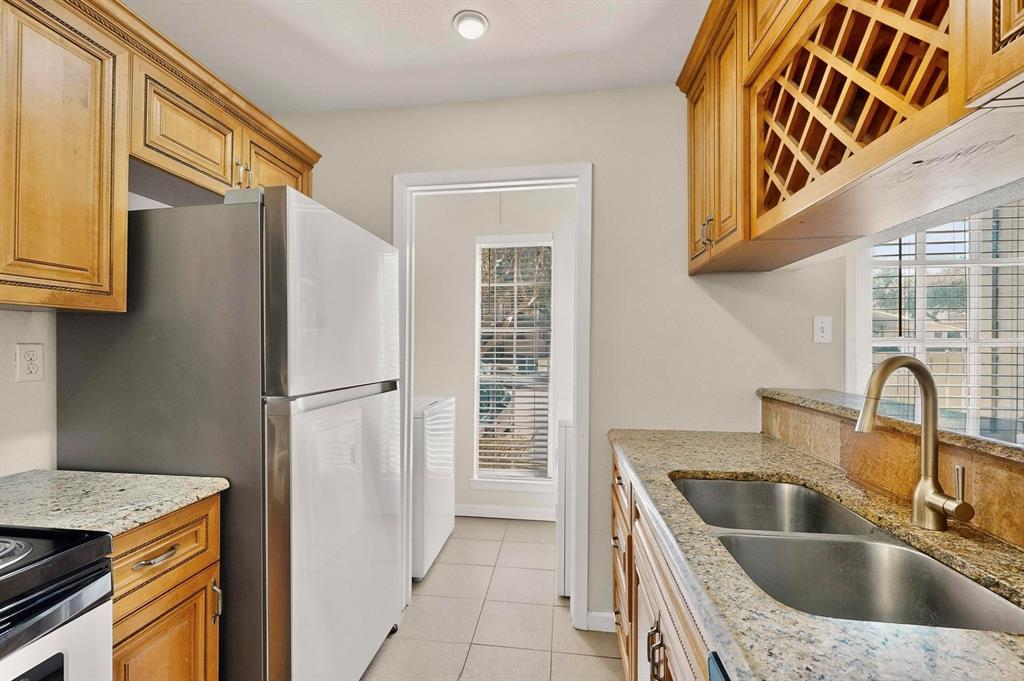 5981 Arapaho Road, Unit 901 Dallas, TX 75248 - Photo 6 of 38 a kitchen with a refrigerator sink and stove
