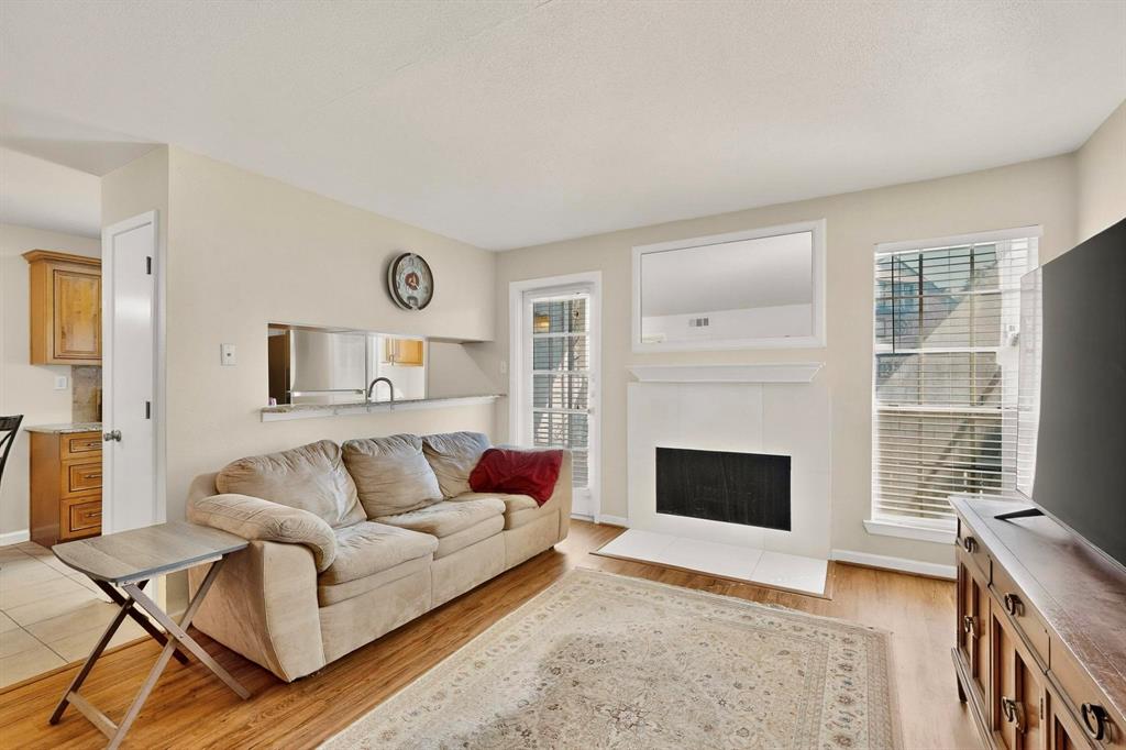 5981 Arapaho Road, Unit 901 Dallas, TX 75248 - Photo 7 of 38 a living room with furniture and a fireplace