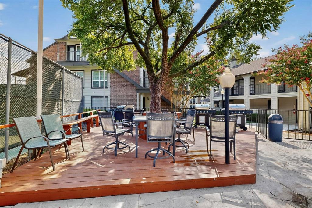 5981 Arapaho Road, Unit 901 Dallas, TX 75248 - Photo 9 of 38 a view of a patio with dining table and chairs with wooden fence and plants