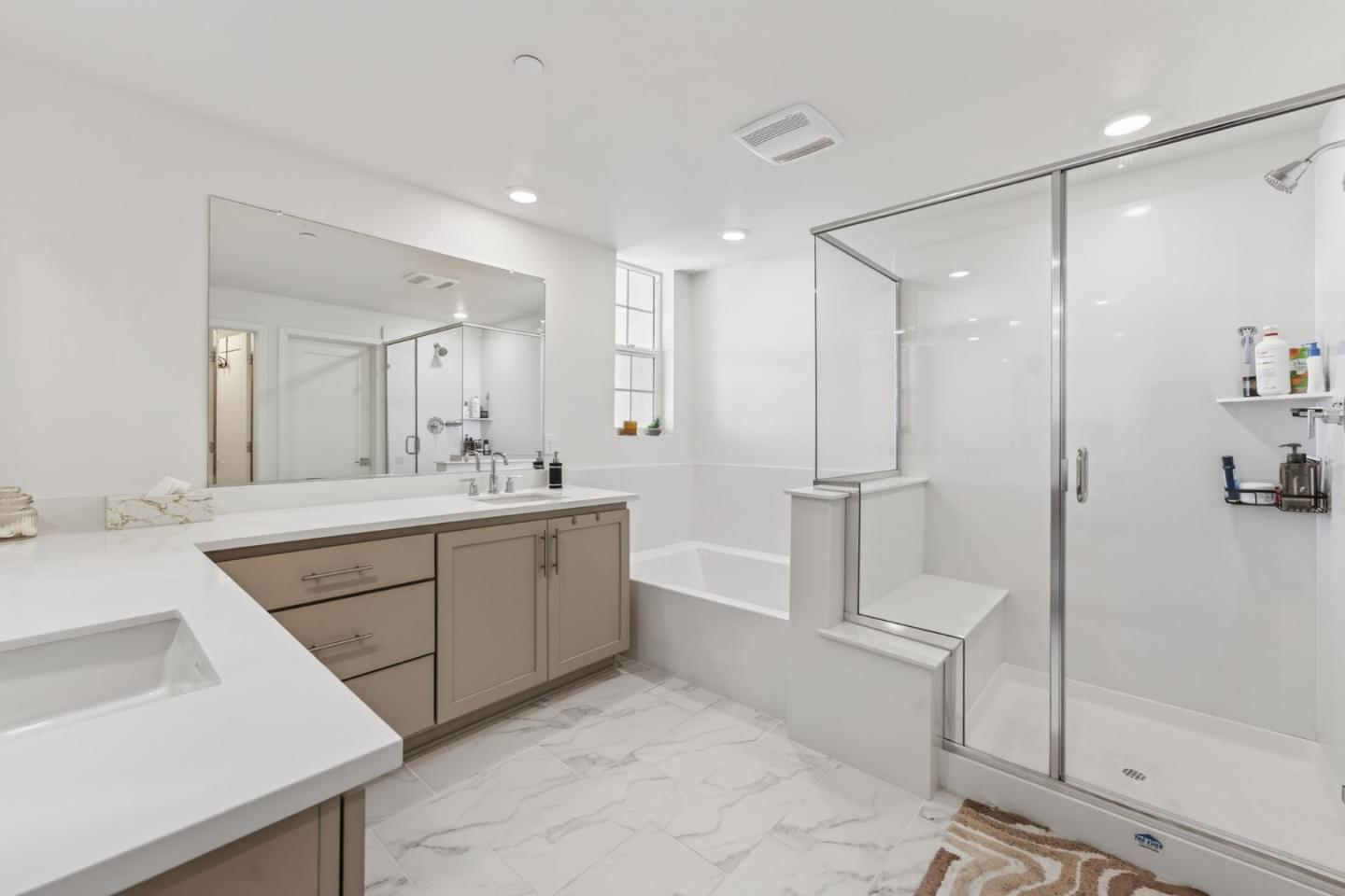9532 Seawind Way Newark, CA 94560 - Photo 27 of 44 a spacious bathroom with a shower sink and mirror