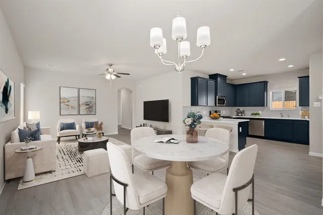 a view of a dining room with furniture and a chandelier