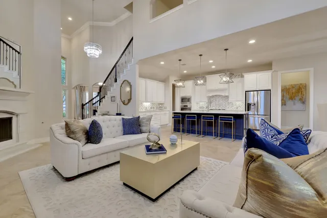 a living room with furniture kitchen view and a couch