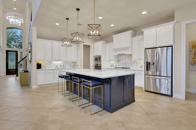 a kitchen with kitchen island a counter top space appliances and cabinets
