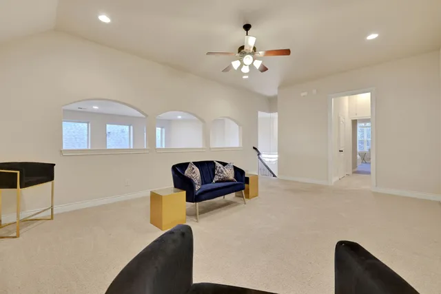 a bedroom with a bed a couch and a window