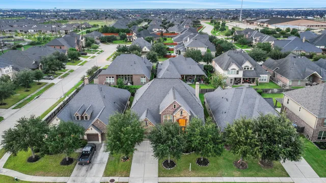 an aerial view of residential houses with outdoor space