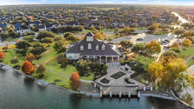 an aerial view of a houses with a lake view