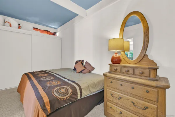 a bedroom with a bed and a dresser