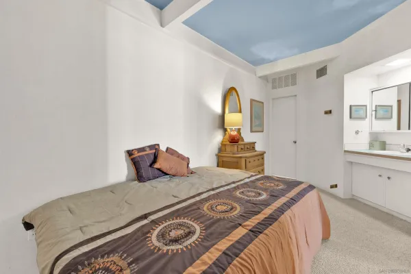 a bedroom with a bed and a dresser