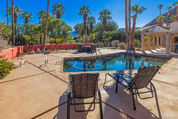 a view of a patio with table and chairs and potted plants