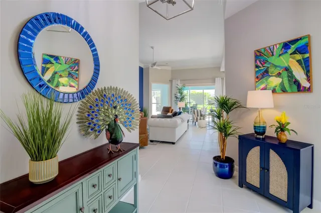 a vase of flowers sitting on a table with a kitchen view