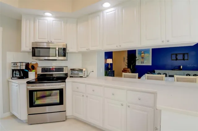 a kitchen with appliances cabinets and a sink