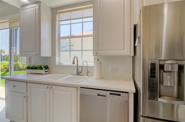 a very nice looking room with a large window and a chandelier