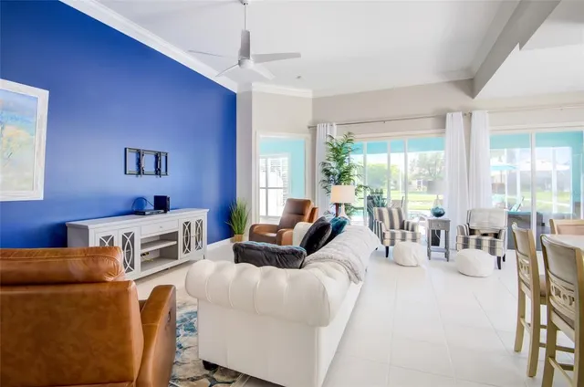 a bedroom with a bed a dresser and potted plants