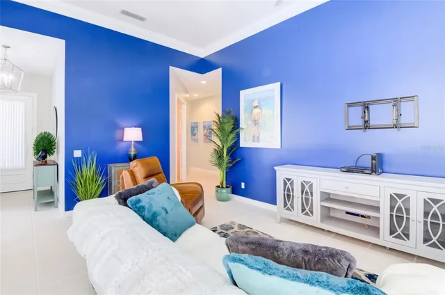 a bedroom with furniture and a flat screen tv