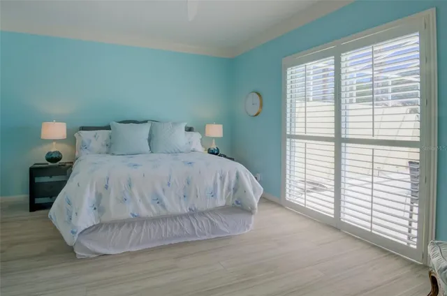 a spacious bedroom with a bed and a cabinets