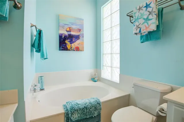 a view of a hallway with wooden floor and closet