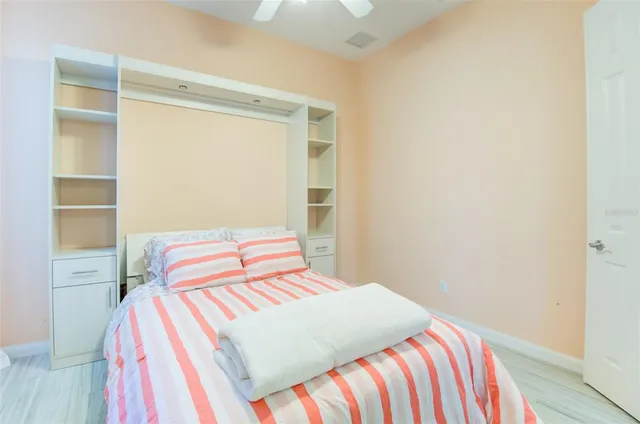 a bedroom with a bed and a lamp