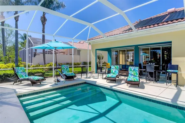 an aerial view of a house with a garden and lake view
