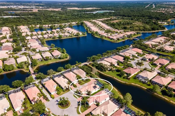 an aerial view of residential houses with outdoor space and river