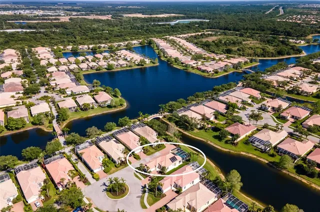 an aerial view of residential houses with outdoor space and river