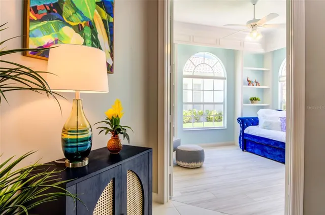 a living room with furniture and a potted plant