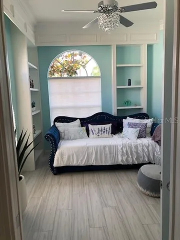 a bedroom with a bed mirror and window