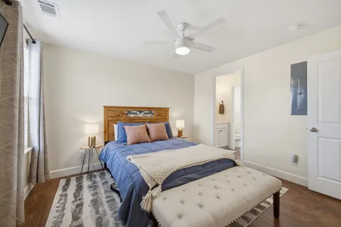 a bedroom with a bed and a flat screen tv