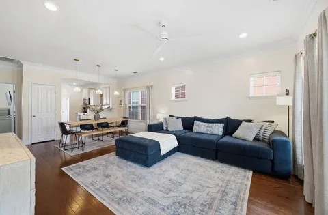 a living room with furniture wooden floor and a table