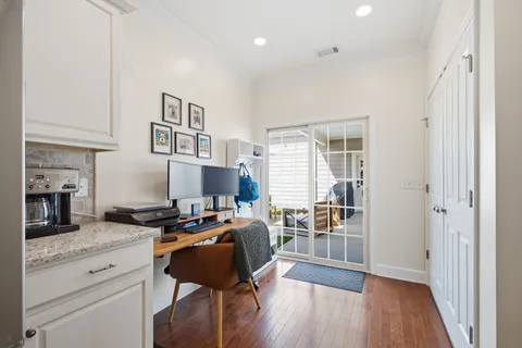 a spacious bedroom with a bed and wooden floor
