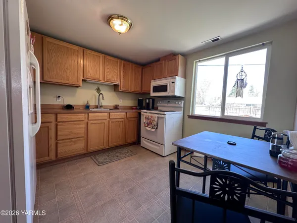 a kitchen with stainless steel appliances a sink stove and cabinets