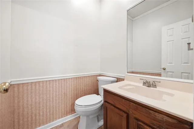 a bathroom with a sink a toilet and vanity