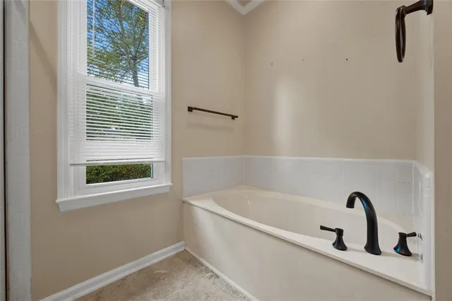 a white bath tub sitting next to a window