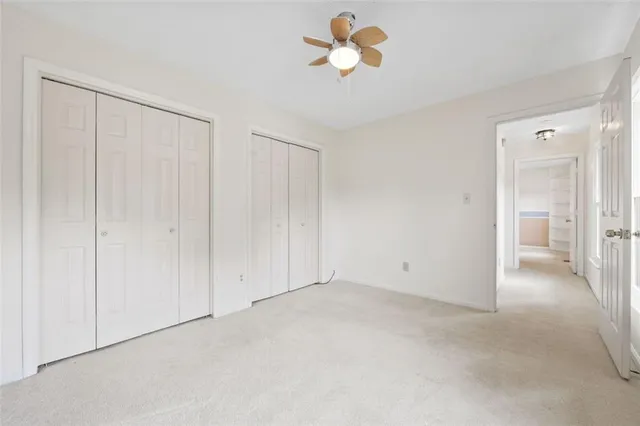 a view of an empty room and a ceiling fan