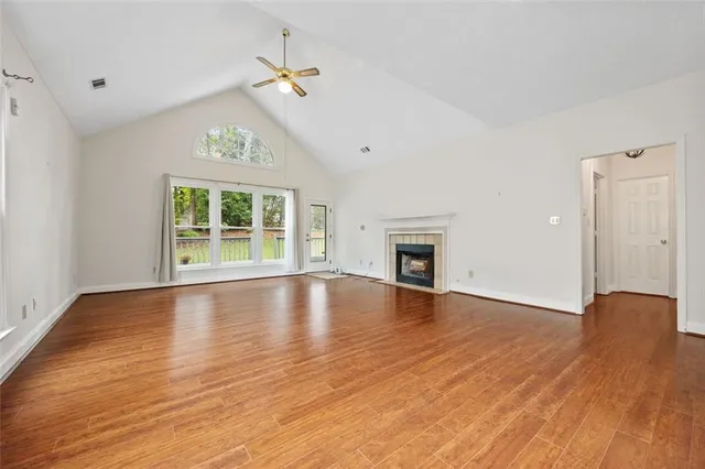 wooden floor in an empty room with a window