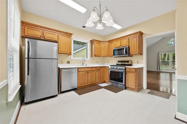 a kitchen with a refrigerator a sink and a stove top oven