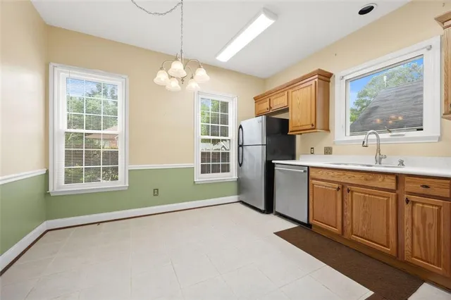 a kitchen with refrigerator a sink and dishwasher