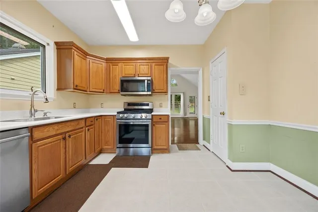 a kitchen with a refrigerator a sink and a stove