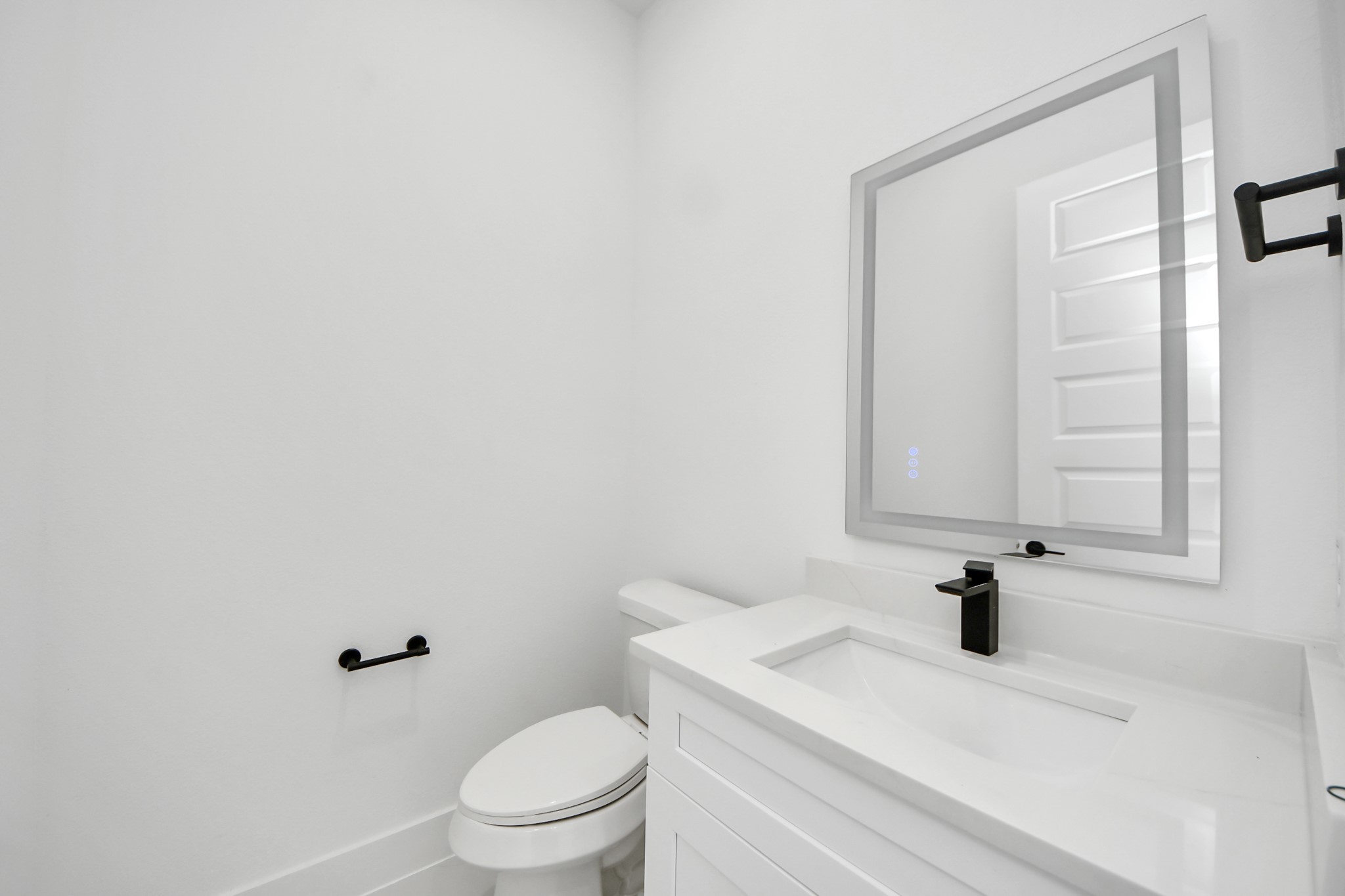 3310 Hardy Street Houston, TX 77009 - Photo 11 of 26 a bathroom with a sink a toilet and a mirror
