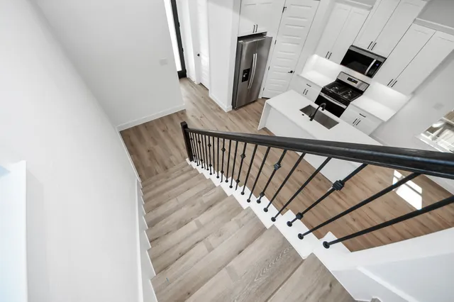a view of a fireplace in kitchen and an empty room